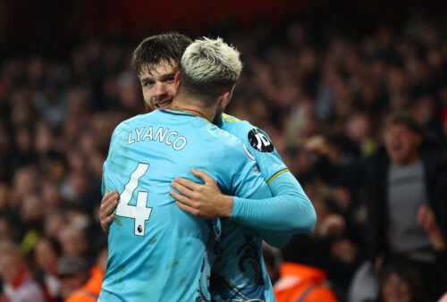 Soccer players celebrate goals.
