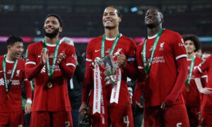Liverpool players with trophy.