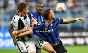 Soccer players contest for ball.