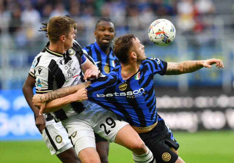 Soccer players contest for ball.