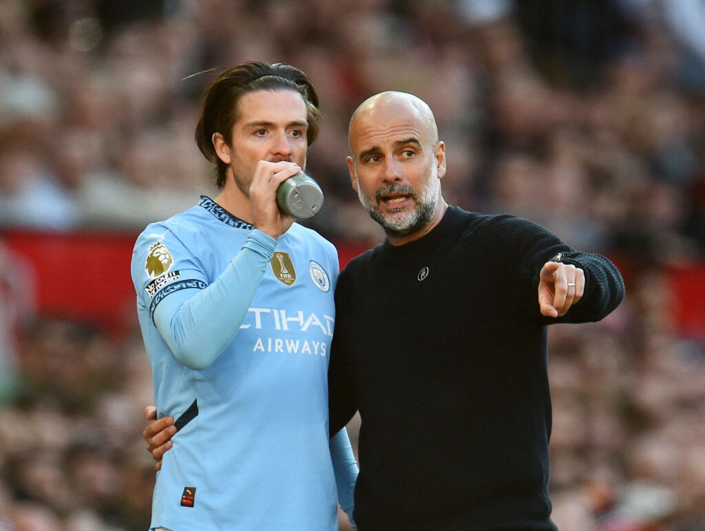 Manchester City manager Pep Guardiola speaks with Jack Grealish. (REUTERS/Peter Powell)