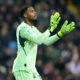 Goalkeeper in green shirt claps.