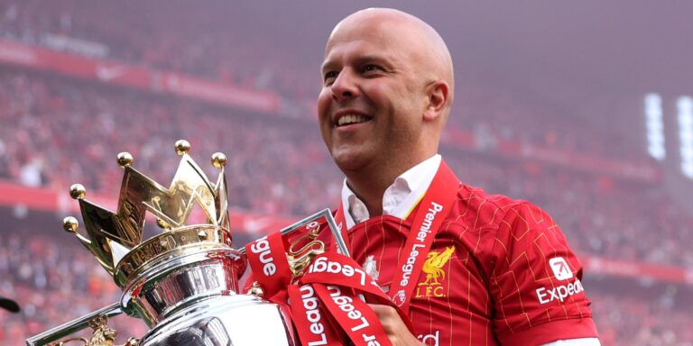 Arne Slot lifts the Premier League title for Liverpool.
