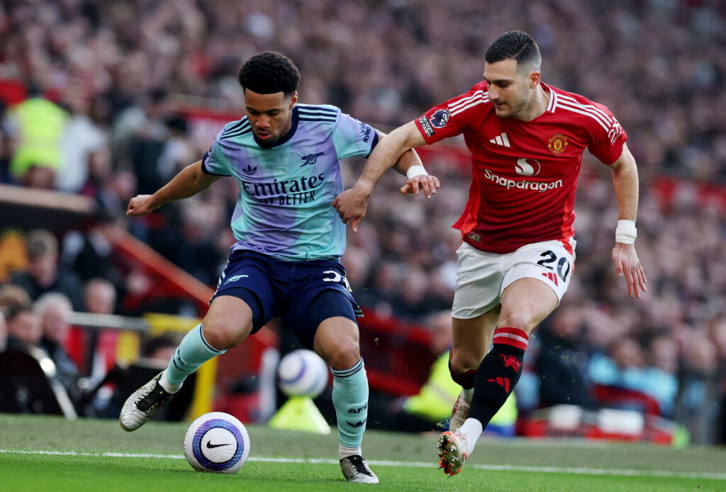 Ethan Nwaneri in action with Manchester United's Diogo Dalot. (REUTERS/Phil Noble)