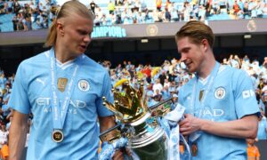 Manchester City's Erling Haaland and Kevin De Bruyne with the Premier League trophy.