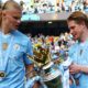 Manchester City's Erling Haaland and Kevin De Bruyne with the Premier League trophy.