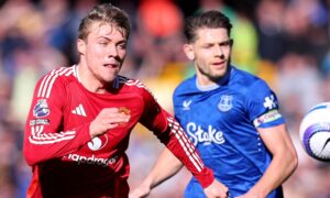Man Utd's Rasmus Hojlund and Everton's James Tarkowski during a Premier League match.