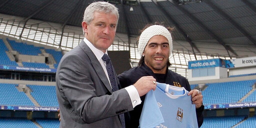 Carlos Tevez and Mark Hughes at Manchester City's stadium.