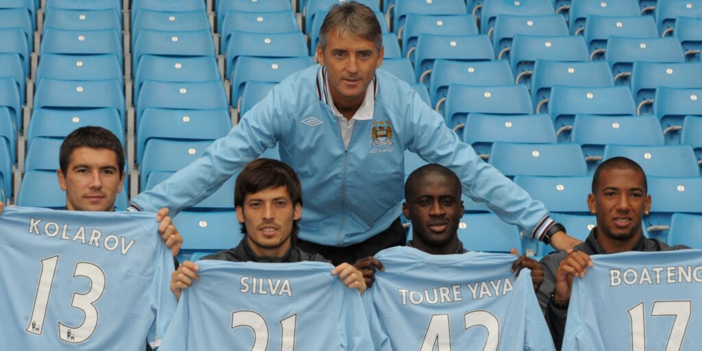 Roberto Mancini with his new signings for the 2010/11 season: Aleksandar Kolarov, David Silva, Yaya Toure & Jerome Boateng.