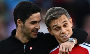 Mikel Arteta and Leandro Trossard of Arsenal