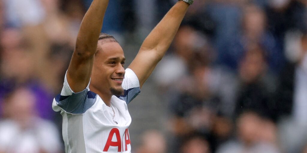 Xavi Simons greets the Tottenham fans after signing for the club.