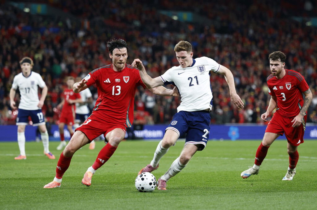 Wales' Kieffer Moore in action with England's Elliot Anderson. (Reuters/Peter Cziborra)