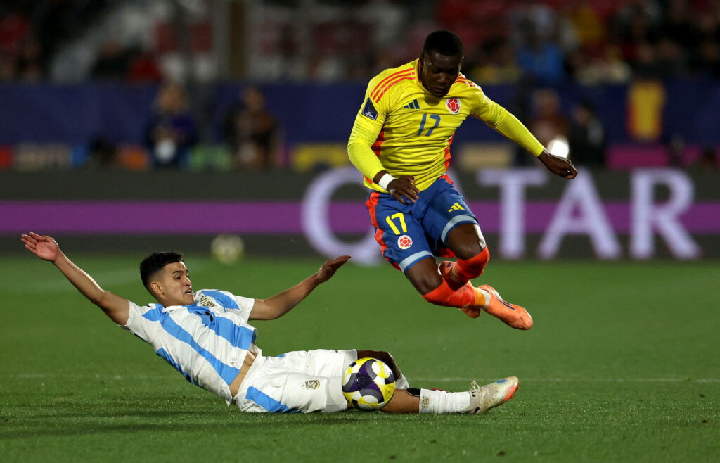 Colombia's Juan David Arizala in action with Argentina's Dylan Gorosito. (REUTERS/Pablo Sanhueza)