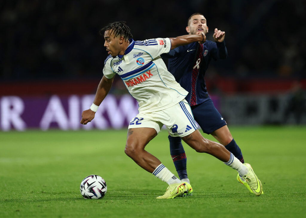Paris St Germain's Lucas Hernandez in action with RC Strasbourg's Guela Doue. (REUTERS/Gonzalo Fuentes)