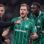 Referee Robert Hartmann talks to Senne Lynen and Karim Coulibaly of Bremen. (Selim Sudheimer/Getty Images)