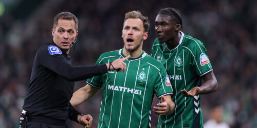 Referee Robert Hartmann talks to Senne Lynen and Karim Coulibaly of Bremen. (Selim Sudheimer/Getty Images)