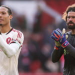 Virgil van Dijk and Alisson Becker. (Carl Recine/Getty Images)